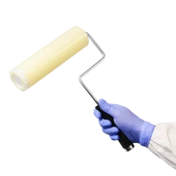 Cleanroom sticky roller, film roller in use - with handle - being held by cleanroom operative. Tacky roller.