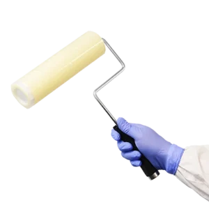 Cleanroom sticky roller, film roller in use - with handle - being held by cleanroom operative. Tacky roller.