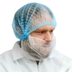 Man wearing blue pleated bouffant cap with a white beard cover and coverall