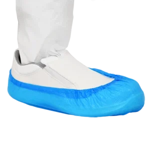 Blue Cleanroom Shoe Cover over a slip-on cleanroom shoe. The cleanroom operative is also wearing cleanroom clothing on their leg